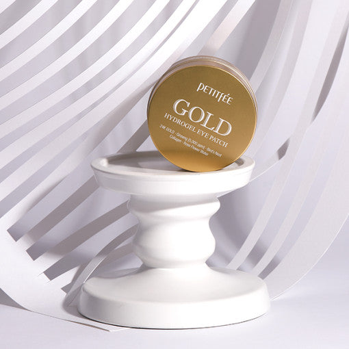 ProtoClinical k-beauty PETITFEE Gold Hydrogel Eye Patch (1.4g X 60 Patches) single dark amber round jar centered on a pale blue background