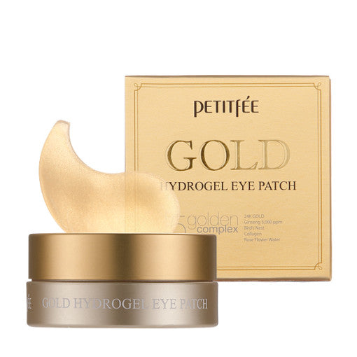ProtoClinical k-beauty PETITFEE Gold Hydrogel Eye Patch (1.4g X 60 Patches) single warm gold package laid horizontally on a pale blue and cream background