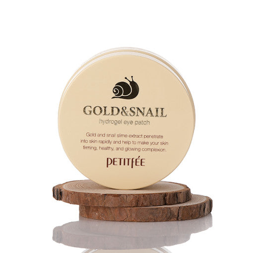 ProtoClinical k-beauty PETITFEE Gold Snail Hydrogel Eye Patch (1.4g X 60 Patches) open beige round jar above a dark brown lid on a white background