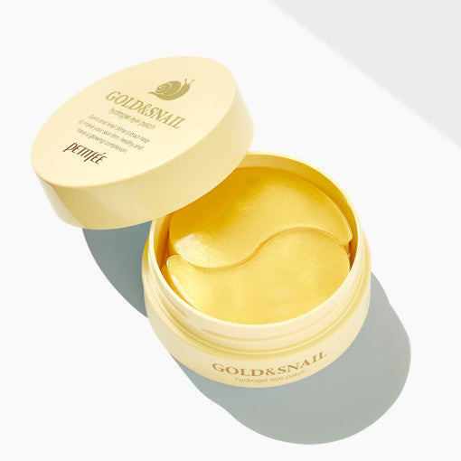 ProtoClinical k-beauty PETITFEE Gold Snail Hydrogel Eye Patch (1.4g X 60 Patches) two golden yellow crescent eye patches mirrored at the center on a pale blue background