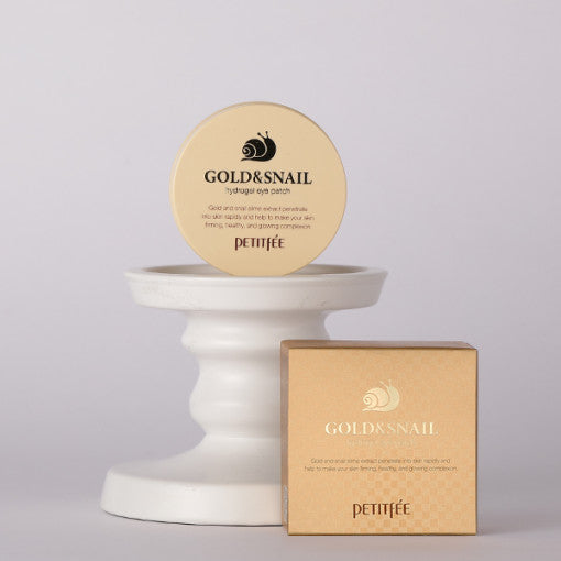 ProtoClinical k-beauty PETITFEE Gold Snail Hydrogel Eye Patch (1.4g X 60 Patches) single pale beige eye patch package standing upright on a light background with pale blue and pink shading