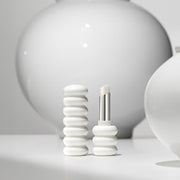 ProtoClinical k-beauty Sulwhasoo Glowing Lip Balm 3g mood image in soft gray and cream tones.