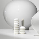 ProtoClinical k-beauty Sulwhasoo Glowing Lip Balm 3g mood image in soft gray and cream tones.