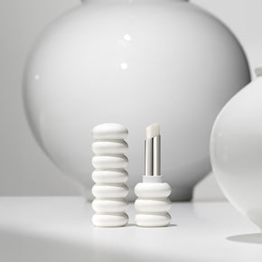 ProtoClinical k-beauty Sulwhasoo Glowing Lip Balm 3g mood image in soft gray and cream tones.