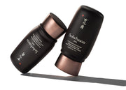 ProtoClinical k-beauty Sulwhasoo MEN UV Defense Protector 50ml SPF50+ PA++++ close-up detail with two dark bottle forms in warm beige and slate blue tones on a light background
