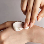 ProtoClinical k-beauty Sulwhasoo The Ultimate S Cream 30ml cream texture with a hand on a light background.