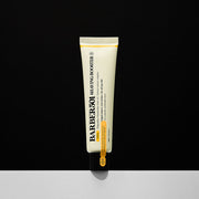 ProtoClinical k-beauty slim beige skincare product centered on a dark background with a soft white base.