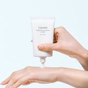 ProtoClinical k-beauty pastel blue and peach beauty product detail on a light background.