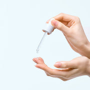 ProtoClinical k-beauty soft peach and white beauty product detail on a light background.
