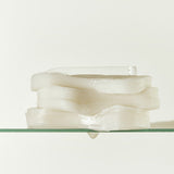 ProtoClinical k-beauty beauty product detail with olive, mauve, and warm beige tones on a light background.