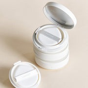 ProtoClinical k-beauty soft beige beauty product close-up with muted gray and lavender tones on a light background.