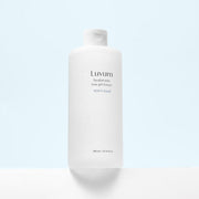 ProtoClinical k-beauty Luvum Witch Hazel Hyaluronic Low pH Toner 300ml light beige vertical package silhouette with dark side framing on a pale background.