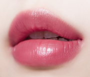 ProtoClinical k-beauty TONYMOLY Get it Tint Syrup Stick single coral-pink oval lip color swatch with a deeper rosy center on a pale background