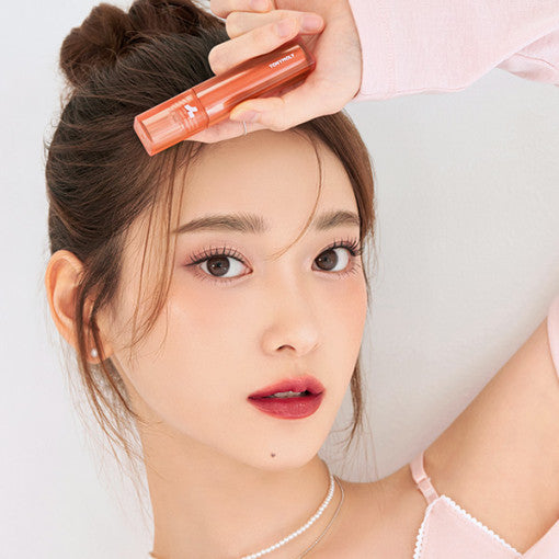 ProtoClinical k-beauty TONYMOLY PERFECT LIPS SHOCKING LIP (14 Colors) 4g single upright coral-peach lip tint tube centered on a pale beige background