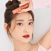 ProtoClinical k-beauty TONYMOLY PERFECT LIPS SHOCKING LIP (14 Colors) 4g single upright coral-peach lip tint tube centered on a pale beige background