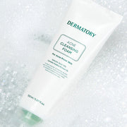 ProtoClinical k-beauty DERMATORY Pro Trouble Acne Cleansing Foam 150ml single upright gray cleansing foam tube centered on a soft white background with pale yellow side accents.