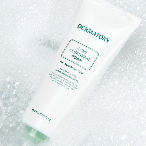 ProtoClinical k-beauty DERMATORY Pro Trouble Acne Cleansing Foam 150ml single upright gray cleansing foam tube centered on a soft white background with pale yellow side accents.