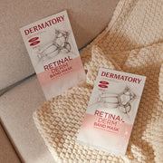 ProtoClinical k-beauty DERMATORY Retinal Derm Band Mask 28g X 10ea two white-and-peach mask sachets laid side by side on a beige knit blanket