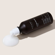 ProtoClinical k-beauty [MARY & MAY] Collagen Booster Lotion 120ml dark taupe lotion package graphic with a horizontal center band on a light background