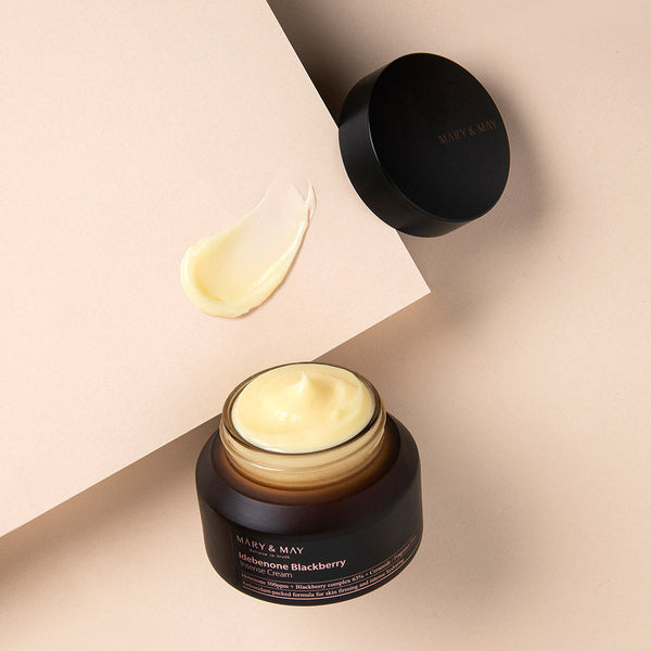 ProtoClinical k-beauty [MARY & MAY] Idebenone + Blackberry Complex Intense Cream 70g in a warm beige graphic with a taupe vertical center band and soft lavender side tones