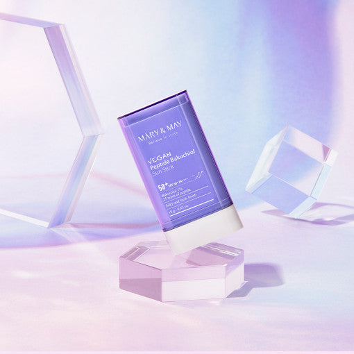 ProtoClinical k-beauty [MARY & MAY] Peptide Bakuchiol Sun Stick SPF50+ PA++++ 18g single lavender sun stick centered on a pale blue and pink background
