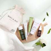 [MARY & MAY] Soothing Trouble Care Travel Kit (5pcs) by ProtoClinical shown with travel kit products on a light neutral background for a k-beauty skincare routine.