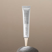 ProtoClinical k-beauty warm beige beauty product silhouette centered on a soft taupe background.