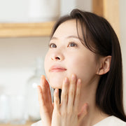 ProtoClinical k-beauty warm beige beauty graphic with a soft peach vertical center and a taupe upper band on a light background.