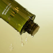 ProtoClinical k-beauty olive beauty graphic with a dark diagonal form on a pale cream background.