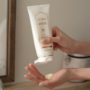 ProtoClinical k-beauty dark brown beauty product silhouette with a pale vertical highlight on a taupe background.