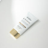 ProtoClinical k-beauty soft taupe beauty product silhouette with a pale center on a muted gray background.