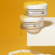 ProtoClinical k-beauty warm yellow and amber beauty product packaging with a soft white center on a light background.
