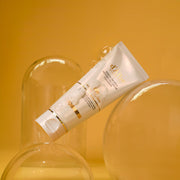 ProtoClinical k-beauty warm amber beauty product packaging with golden tones on a light background.