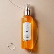 ProtoClinical k-beauty d'Alba White Truffle Royal Intensive Serum 100ml single upright amber serum bottle centered on a light background with soft aqua and peach side shading.