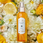 ProtoClinical k-beauty d'Alba White Truffle Royal Intensive Serum 100ml single upright amber serum bottle centered on a light background with soft aqua and peach side shading