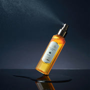 ProtoClinical k-beauty d'Alba White Truffle Royal Intensive Serum 100ml single upright amber serum bottle centered in a square product shot on a light background with soft aqua and peach side accents