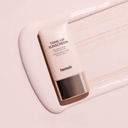 ProtoClinical k-beauty taupe beauty bottle silhouette with cool blue accents on a light background.