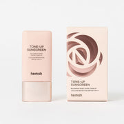 ProtoClinical k-beauty warm beige makeup swatch centered on a light background.