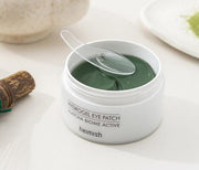 ProtoClinical k-beauty heimish Matcha Biome Hydrogel Eye Patch 1.4g X 60pcs open white round jar filled with dark green crescent eye patches on a pale green water-ripple background