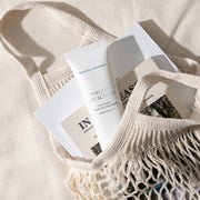 ProtoClinical k-beauty warm beige beauty product silhouette with a muted brown center on a light background.
