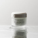 ProtoClinical k-beauty pale gray beauty product silhouette with a soft olive center on a white background.