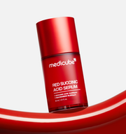 ProtoClinical k-beauty MEDICUBE: Red Succinic Acid Serum (30ml) single upright red serum bottle centered on a pale background with soft blue side accents