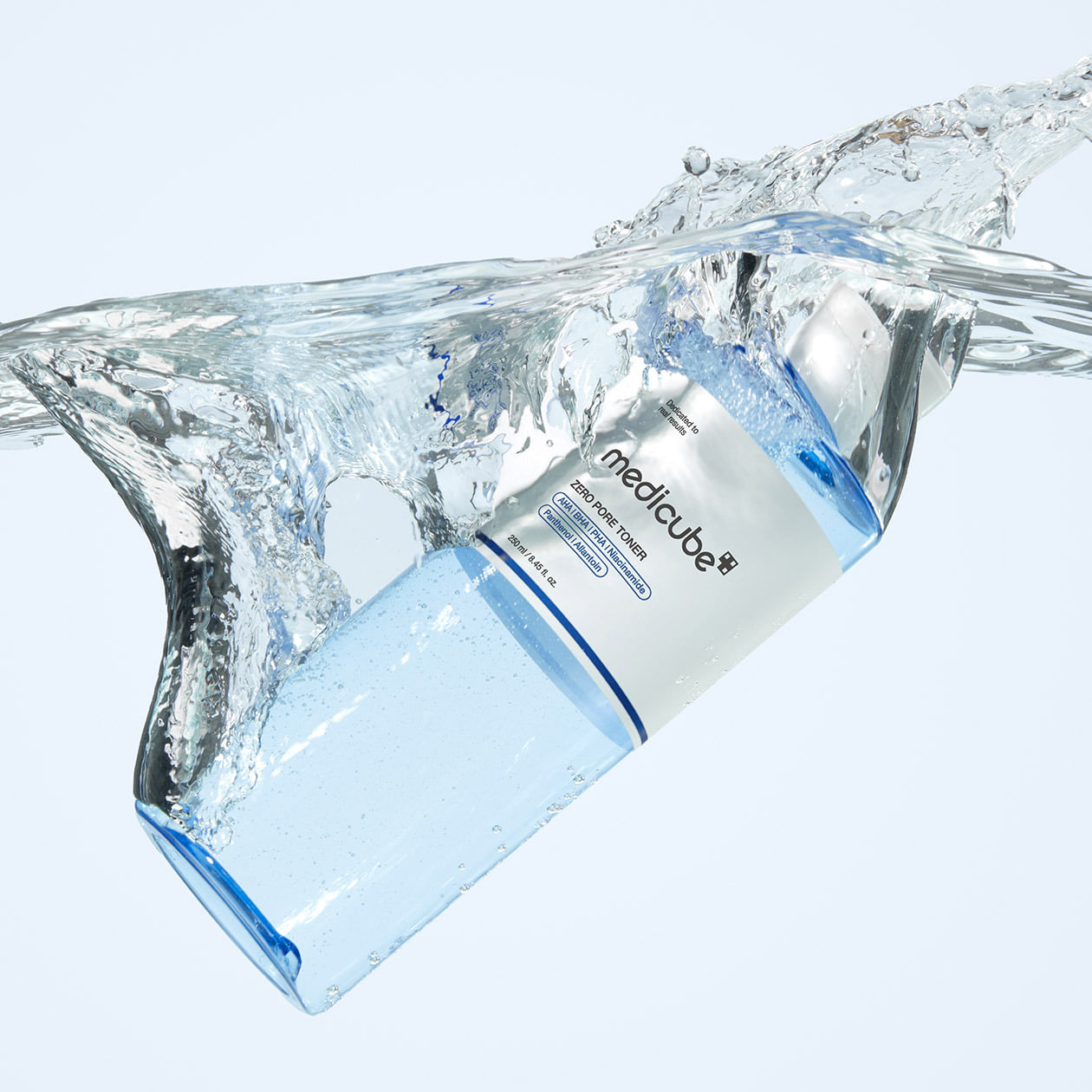 ProtoClinical k-beauty MEDICUBE: Zero Pore Toner (250ml) translucent blue toner bottle angled under a clear water splash with a white label