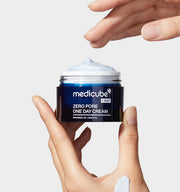 ProtoClinical k-beauty MEDICUBE: Zero Pore One Day Cream (50ml) single gray-blue cream jar centered on a warm beige and white background
