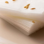 ProtoClinical k-beauty [SOME BY MI] Galactomyces Glutathione Daily Mask 30 Sheets shown as a close-up stack of folded white sheet masks with small tan grains scattered on top