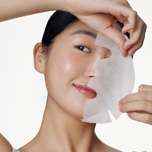 ProtoClinical k-beauty [SOME BY MI] Galactomyces Glutathione Daily Mask 30 Sheets shown on a smiling model holding a translucent sheet mask across her face against a white background