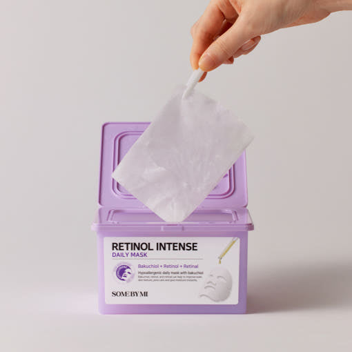ProtoClinical k-beauty [SOME BY MI] Retinol Intense Daily Mask 30 Sheets/350ml lavender tub with a white sheet mask lifted by tweezers above the open container on a light gray background