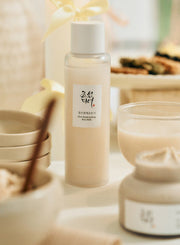 ProtoClinical k-beauty [Beauty of Joseon] Glow Replenishing Rice Milk 150ml beige bottle and matching box side by side on a light background