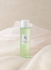 ProtoClinical k-beauty [Beauty of Joseon] Green Plum AHA BHA Toner 150ml translucent light green toner bottle with a white cap standing upright on soft white draped fabric