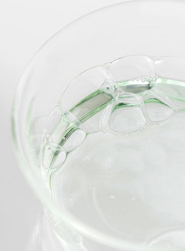 ProtoClinical k-beauty [Beauty of Joseon] Green Plum AHA BHA Toner 150ml close-up of clear gel bubbles and pale green liquid inside a translucent glass dish on a white background